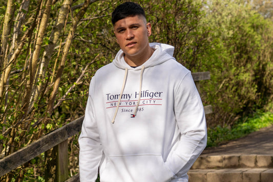 Plus size model wearing Tommy Hilfiger hoodie in the woods